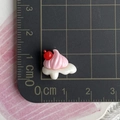 Macro shot of mini resin cream dessert charm with dimensions shown on a ruler - Mini Cherry Cream