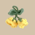 Detail showing knit texture of a handmade yellow crochet lily of the valley keychain - Yellow
