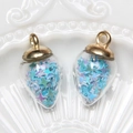 Macro detail of heart-shaped glass pendants with gold caps and colorful star sequins - Water Drop / Blue
