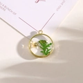 Golden round resin pendant with white dried flowers and green leaves for DIY jewelry - Style 15