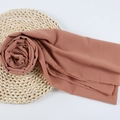 Brick red chiffon hijab scarf with delicate rolled edges in a floral fold display - 109