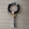 Silicone beaded keychain bracelet with zebra pattern beads and a black tassel pendant - Cow Print Series