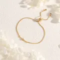 Detail of adjustable gold slider bracelet with starburst pendant and box chain - Hexagram
