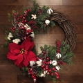 Artificial Christmas wreath with pine needles, red berries, and poinsettia on wood floor - Scotland Style / 30cm