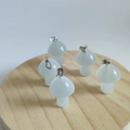 Semi-transparent white mini mushroom crystal pendant with silver metal clasp on wood base - Synthetic White Cat Eye