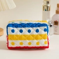 Colorful quilted cotton makeup bag featuring vibrant stripes and polka dot patterns on a vanity - Colorful Stripes and Dots