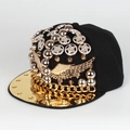Detail of punk hip-hop cap featuring gold wings, metal studs, and a bold chunky chain - Adjustable / Black