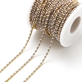 DIY gold metal chain featuring alternating purple rhinestones and white pearls on a spool - 2mm Purple