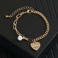 Detail of gold heart pendant with sparkling zircons and a white pearl on the bracelet - Gold Heart Zirconia Pearl Bracelet (xp-131)