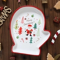 Keramiek kerstbord in de vorm van een want met de Kerstman op een donkere houten tafel - Handschoenenlade 233*193*3cm