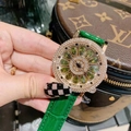 Luxury ladies spinning watch with green flower dial and sparkling crystal bezel on wrist - Green Strap with Colorful Rhinestones