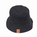 Detail of a black cotton bucket hat showing breathable vents and a brown leather logo patch - M (56-58cm) / Black