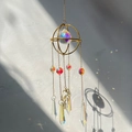 Golden suncatcher with crystal prisms creating rainbow light spots on wall - Round Frame Leaf