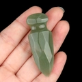 Green aventurine quartz dagger carving gemstone model shown in hand against black background - Green Aventurine
