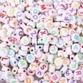 Close-up of bulk white acrylic alphabet beads with colorful letters for DIY jewelry - 4x7mm White With Colored Letters (100pcs)