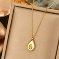Close-up of gold avocado pearl pendant necklace displayed on premium silk fabric - Avocado Enamel Pendant