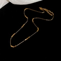 Detail of adjustable golden beaded square link chain necklace with lobster clasp - Gold