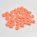 Macro shot of 10mm coral heart-shaped resin beads with LOVE engraving for DIY crafts - Orange Red