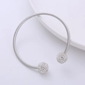 Macro shot of silver twisted rope open cuff bracelet with two sparkling crystal pavé balls - Rhinestone Ball Style