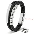 Close-up of black braided leather men's bracelet with silver stainless steel tube and magnetic clasp - Steel Color Custom Tag