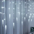 Cold white LED icicle curtain lights hanging on curtains for festive indoor decoration - 110V US Plug / White