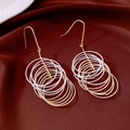 Detail of multi-layered round tassel pendant earrings on elegant dark red satin - Ear Hook - Gold - Silver