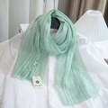 Detailed macro view of light green linen blend striped scarf with frayed edges - Light Green
