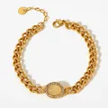 Gold plated stainless steel chain bracelet featuring an oval cat eye stone and tiny crystals - Yellow Agate Style (SAK858)