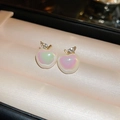 Macro detail of pearlescent apple-shaped earrings with gold leaves on pink velvet - Golden Rhinestone Apple Stud Earrings (HE18003)