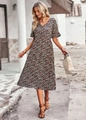 Close-up of a floral V-neck midi dress with small colorful flowers on a dark base - 2XL / Black