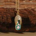Golden sandal pendant necklace with blue enamel evil eye inlay and zircon stones - Dark Green Evil Eye