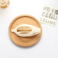 Creamy beige matte oval cutout hair clip with non-slip teeth on a wooden tray - Matte White