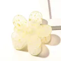 Close-up of a translucent yellow flower hair claw clip with golden glitter details - Leopard Spot Flower Hair Clip - Yellow