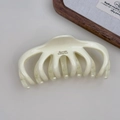 Detail of a creamy beige octopus hair claw with Barrette LaFrance text and claw teeth - Milk White