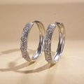 Close-up of silver flower hoop earrings with zircon stones and polished metallic finish - Silver