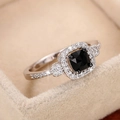 Luxurious square black gemstone ring with pavé diamond accents on a beige velvet box - US 5 / White Gold