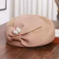 Elegant wool beret with large bow, mesh veil and pearl accents in apricot beige - M (56-58cm) / Camel