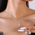 Close-up of sparkling teardrop zircon necklace and matching earrings set on a model - 2-Piece Set / Silver