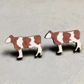Detail view of cow-shaped wooden stud earrings with brown and white spotted patterns - 11-Brown Cow Shape