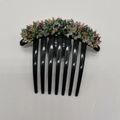 Detail of colorful crystal beads and handmade wire wrapping on a black hair comb accessory - Green Gradient