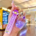 Detailed close-up of a purple unicorn glitter keychain featuring a floating sand bottle - Purple Luminous Bubble Bead Gas Tank