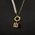 Elegant stainless steel pearl necklace featuring Old English letter W and red crystal pendant - Gothic Letter W