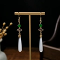 Macro shot of long beaded tassel earrings with green beads and white teardrop pendants - Green Bead Long White Water Drop (E1250-3)