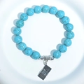 Turquoise bead bracelet featuring a silver $100 bill money charm on white background - Blue Turquoise $100 Bill Charm