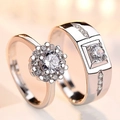 Detailed close-up of silver and rose gold plated couple rings with sparkling cubic zirconia - Two Carat Love