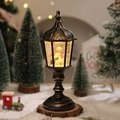 Macro detail of a vintage bronze snow globe lantern with snowman and warm festive lights - Snowman