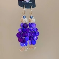Detail of fish-shaped shell earrings with purple sequins and evil eye charm - Ear Hook Gold Purple Fish