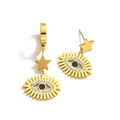 Gold evil eye earrings with blue crystals and star charm on a clean white background - Gold