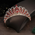 Macro shot of gold wedding tiara featuring red rhinestones and sparkling crystal accents - Gold Red Zirconia