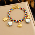 Macro shot of colorful braided rope bracelet featuring enamel flower and gold heart charms - Black and White Flower and Butterfly Style (B1799)